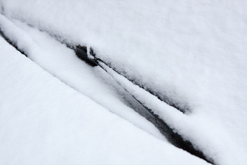 car windshield covered with snow. car detail in winter. Layout for decor and design at transportation. Automobile exterior part. Texture background. Copy space for text