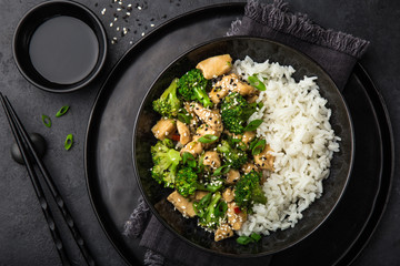 teriyaki chicken and broccoli with steamed rice in bowl