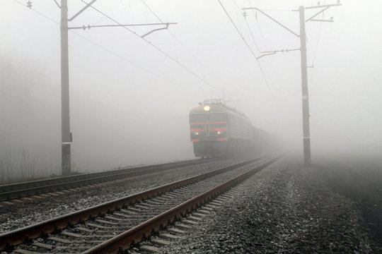 Fototapeta Freight train leaves the fog