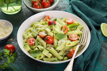 penne pasta with creamy avocado sauce and tomatoes