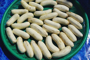 Whole peeled bananas drying in the sun in Luang Prabang, Laos