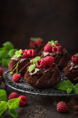 delicious chocolate muffins with chocolate topping and fresh raspberry