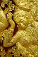 Closeup detail of gold leaf decoration on Buddhist temple in Luang Prabang, Laos