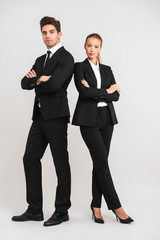 Full length of confident young business couple