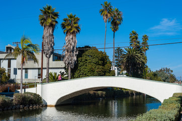 Woman crossing bridge on the Venice Beach Canals neighbourhood near Los Angeles California