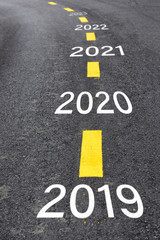 Number of 2019 to 2023 on asphalt road surface with marking lines, happy new year concept