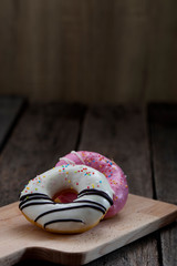 Glazed mini donuts on wooden background
