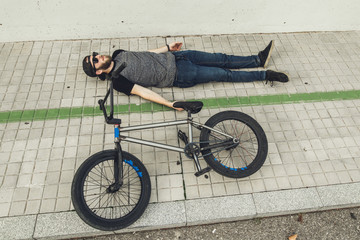 Young man with a bmx bike on the street.Rider BMX