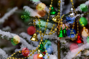 Bright colorful festive Christmas garlands decorate the Christmas tree. Dark style. Horizontal...