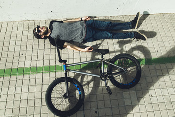 Young man with a bmx bike on the street.Rider BMX