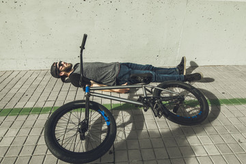 Young man with a bmx bike on the street.Rider BMX