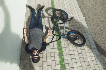Young man with a bmx bike on the street.Rider BMX