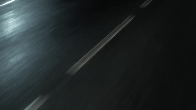 night trip. marking on wet asfalt in the headlights