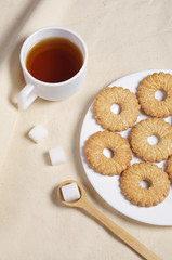 Cookies and tea on fabric background