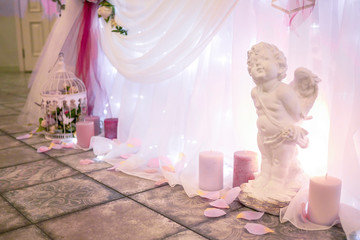 statue of the white wedding angel with candles