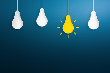 Yellow paper light bulb on blue background. Creative idea, new idea and innovation concepts.