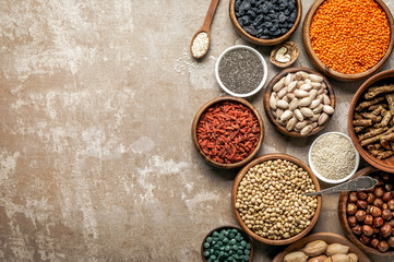 top view of superfoods, legumes and healthy ingredients on rustic background with copy space