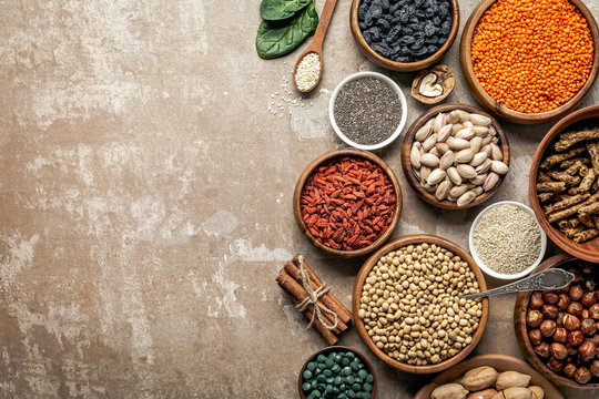 top view of superfoods, legumes and healthy ingredients on rustic background with copy space © LIGHTFIELD STUDIOS