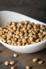 selective focus of soybean in white bowl on table