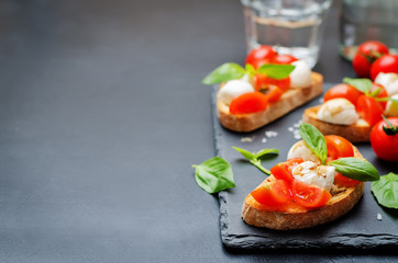 Caprese bruschetta with fresh tomatoes and Basil leaves