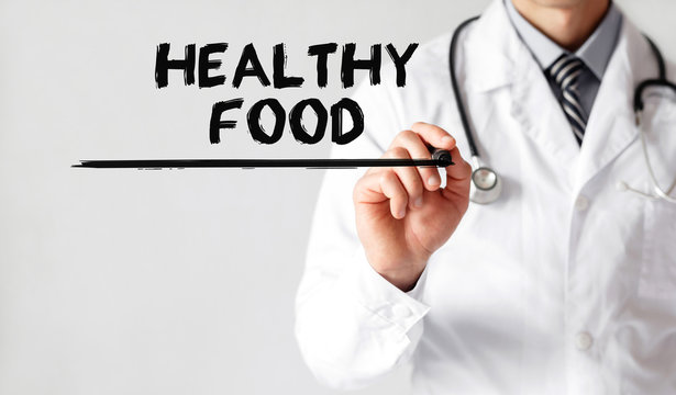 Doctor writing word Healthy Food with marker, Medical concept