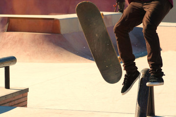 Teenage skateboarder boldly makes extreme jumps on a skateboard