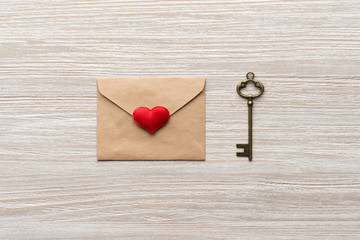 Envelope with heart, key on wooden background top view. Valentine's Day. 14 february.