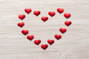red heart nested heart on wooden background top view. Valentine's Day. 14 february.