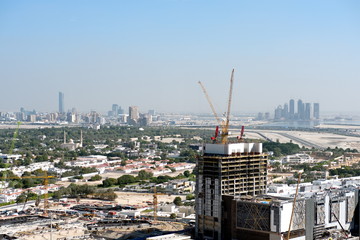 Aerial view of under construction building with cranes from downtown, visible whole Zabeel district, Dubai Creek harbor, Dubai Canal to Business Bay and Al Khail road