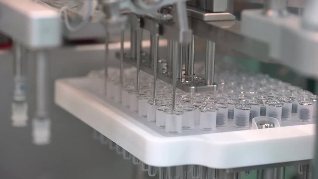 Pharmaceutical manufacturing line automatic machine at factory. Production equipment at pharmacy medical industry. quality control vials ampules vaccines vaccine viruses medicine healthcare medicines