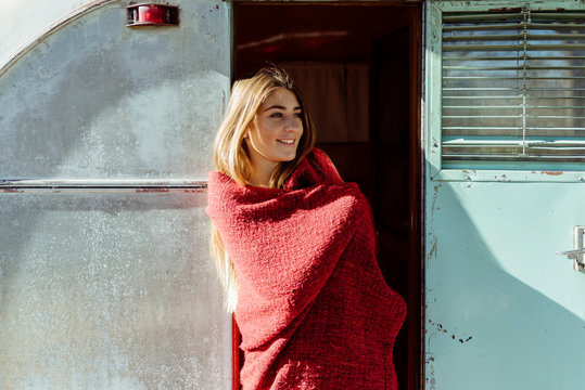 Cheerful Woman In Blanket Standing Near Van