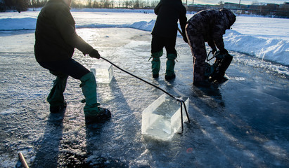 Workers mine large cubes of natural river ice. Ice block. A large block of sawed-up river ice.