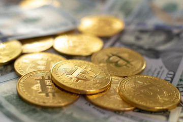 golden bitcoin coin on us dollars close up