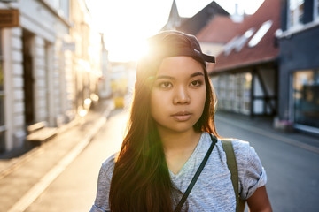 Stylish young Asian woman walking through the city