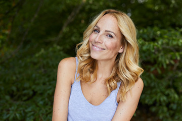 Portrait of smiling blond woman outdoors