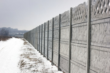 Concrete fence. Winter. Nature