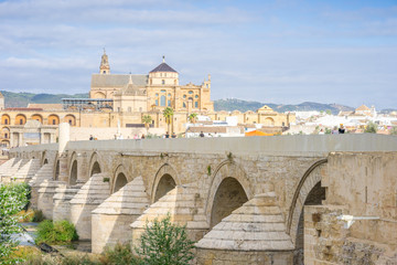 Naklejka na ściany i meble Roman bridge and cathedral - mosque by the river in Cordoba, Andalusia, Spain