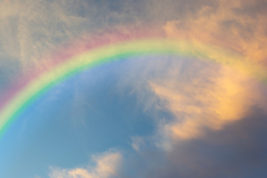 Beautiful Classic Rainbow Across In The Blue Sky After The Rain, Rainbow Is A Natural Phenomenon That Occurs After Rain.