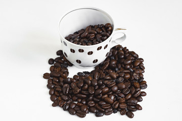 cup of coffee with beans on white background