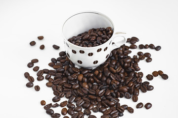 cup of coffee with beans on white background