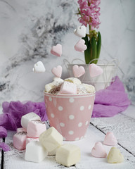 A cup of latte with hart-shaped marshmallows