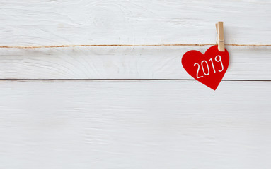 Red paper heart with 2019 word hanging on the rope