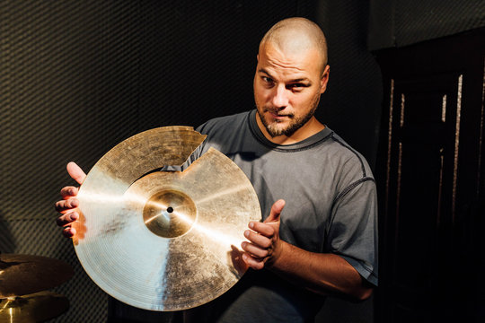 Drummer showing a broken cymbal