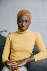 selective focus of confident african american woman with short hair