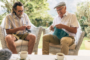 Retired male friends doing knitting