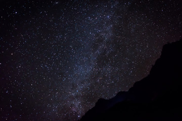 milky way stars behind mountain