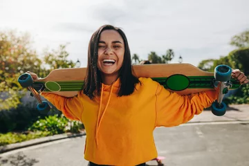 Fotobehang Skateboard Girl standing in street with a longboard  © Jacob Lund
