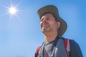 Caucasian male tourist wearing a hat