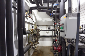 House heating system with many steel pipes, manometers and metal tubes and automated control equipment