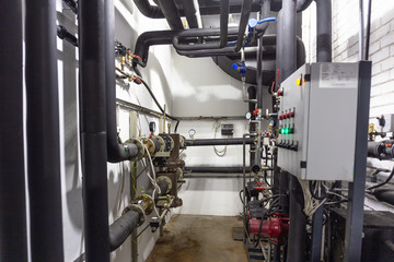 House heating system with many steel pipes, manometers and metal tubes and automated control...